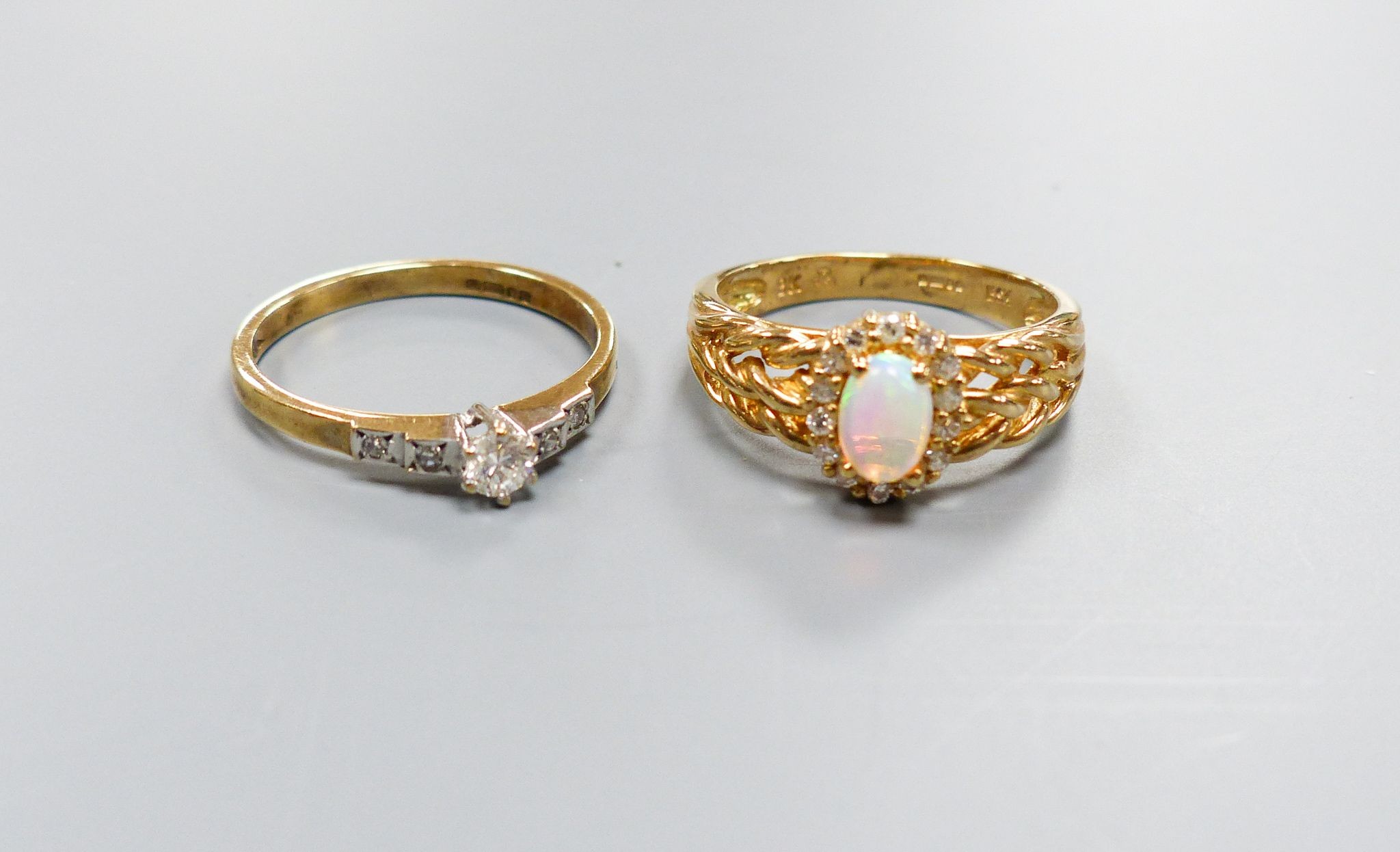 A modern 9ct gold, white opal and diamond set oval cluster ring, size M and a similar single stone diamond ring with diamond set shoulders, size M/N, gross weight 4.6 grams.